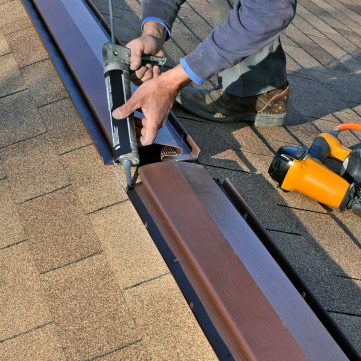 Man caulking ridge vent Man caulking ridge vent on new addition